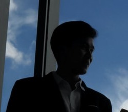 Silhouettes of two business people discussing in the office.